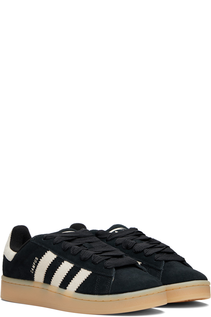 Low-top suede sneakers.

· Lace-up closure
· Padded tongue and collar
· Logo printed at tongue and heel tab
· Text printed at outer side
· Perforations and signature serrated stripes at sides
· Terrycloth and mesh lining
· Treaded rubber sole

Supplier color: Core black/Cream white/Gum
