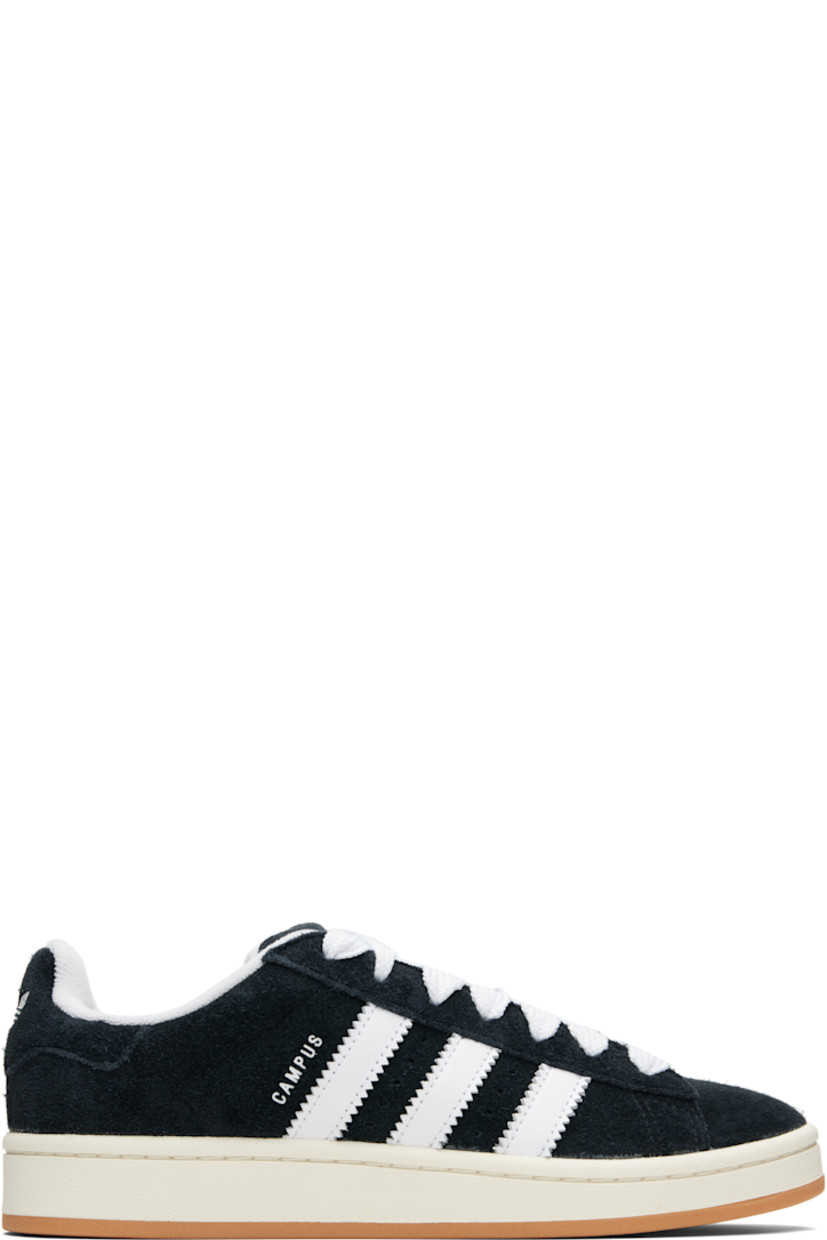 Low-top suede sneakers.

· Lace-up closure
· Padded tongue and collar
· Logo printed at tongue and heel tab
· Text printed at outer side
· Perforations and signature serrated stripes at sides
· Terrycloth and mesh lining
· Treaded rubber sole

Supplier color: Core black/Cloud white/Off white
