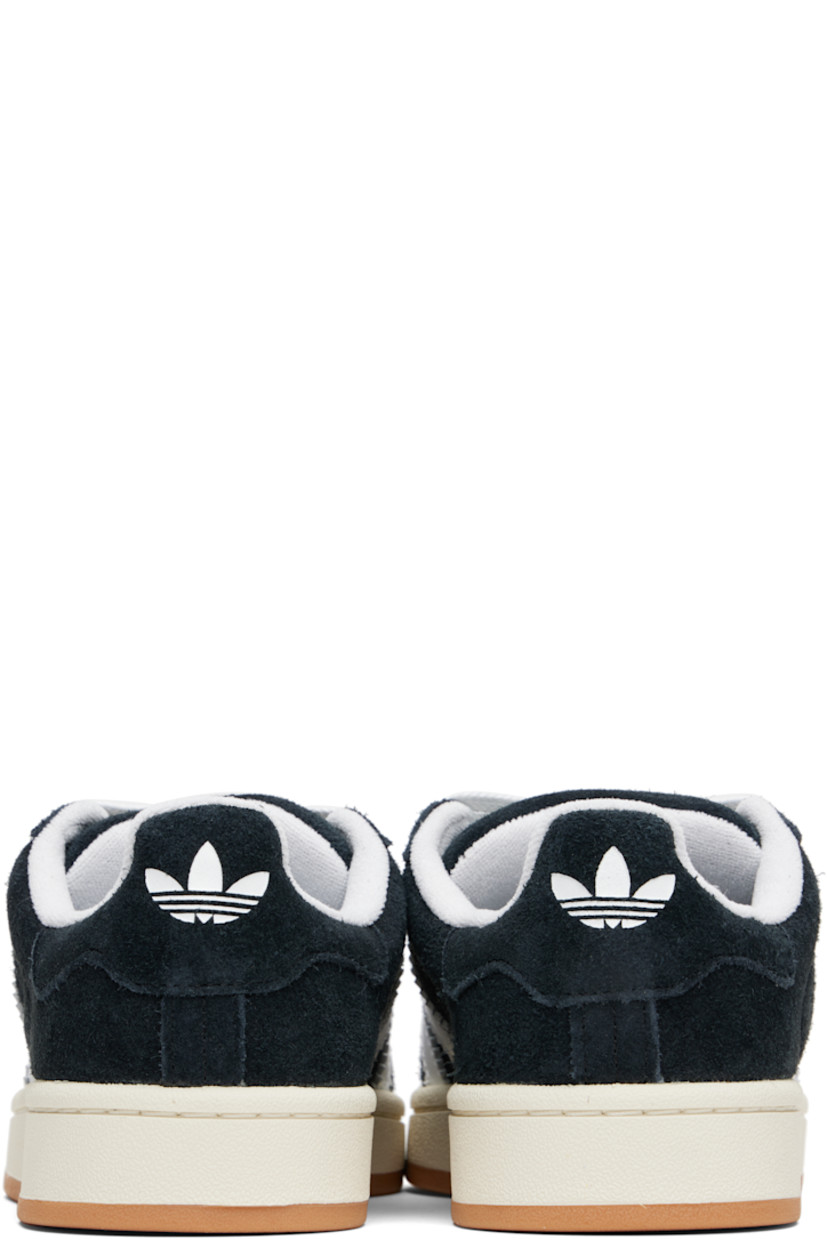 Low-top suede sneakers.

· Lace-up closure
· Padded tongue and collar
· Logo printed at tongue and heel tab
· Text printed at outer side
· Perforations and signature serrated stripes at sides
· Terrycloth and mesh lining
· Treaded rubber sole

Supplier color: Core black/Cloud white/Off white
