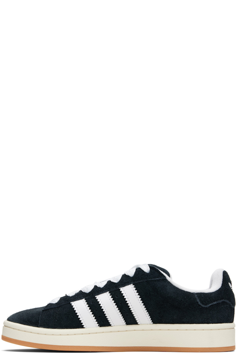 Low-top suede sneakers.

· Lace-up closure
· Padded tongue and collar
· Logo printed at tongue and heel tab
· Text printed at outer side
· Perforations and signature serrated stripes at sides
· Terrycloth and mesh lining
· Treaded rubber sole

Supplier color: Core black/Cloud white/Off white