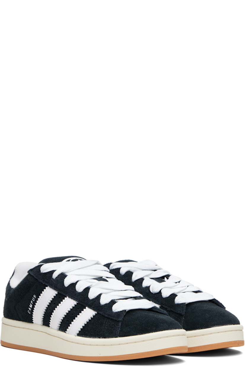 Low-top suede sneakers.

· Lace-up closure
· Padded tongue and collar
· Logo printed at tongue and heel tab
· Text printed at outer side
· Perforations and signature serrated stripes at sides
· Terrycloth and mesh lining
· Treaded rubber sole

Supplier color: Core black/Cloud white/Off white