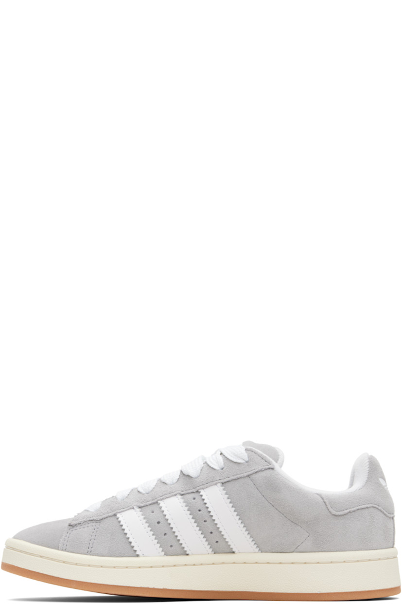 Low-top suede sneakers.

· Lace-up closure
· Padded tongue and collar
· Logo printed at tongue and heel tab
· Text printed at outer side
· Perforations and signature serrated stripes at sides
· Terrycloth and mesh lining
· Treaded rubber sole

Supplier color: Grey three/Cloud white/Off white