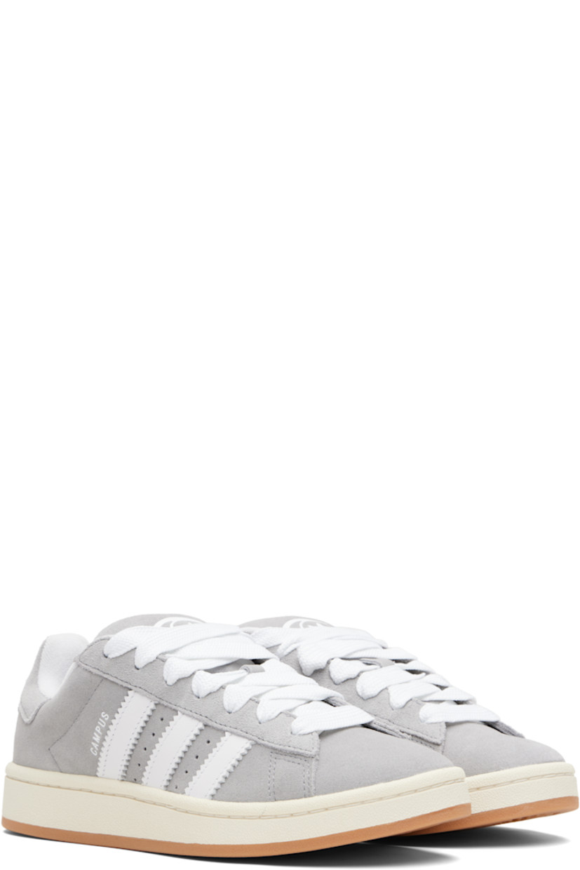 Low-top suede sneakers.

· Lace-up closure
· Padded tongue and collar
· Logo printed at tongue and heel tab
· Text printed at outer side
· Perforations and signature serrated stripes at sides
· Terrycloth and mesh lining
· Treaded rubber sole

Supplier color: Grey three/Cloud white/Off white