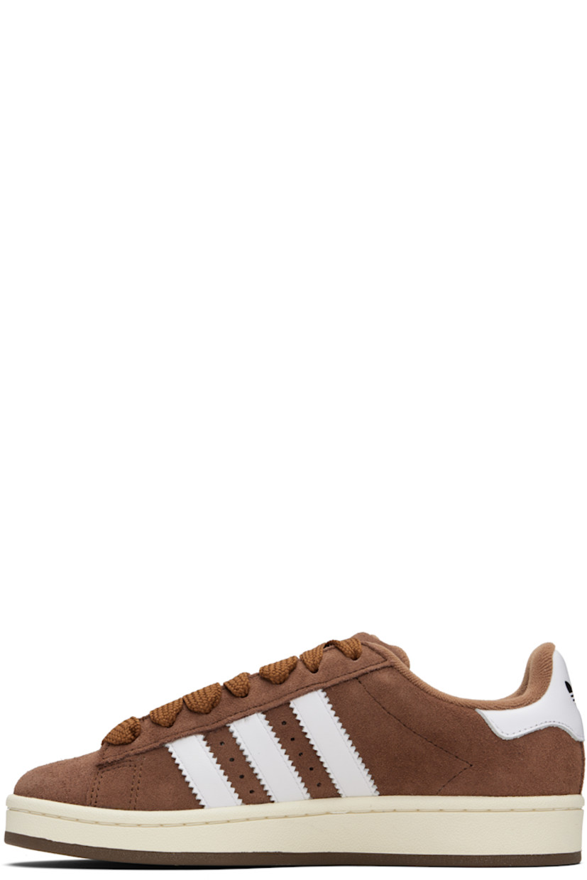 Low-top suede and buffed leather sneakers.

· Lace-up closure
· Logo embossed at tongue
· Padded tongue and collar
· Perforations at sides
· Signature serrated stripes
· Text stamp at outer side
· Logo embossed at heel tab
· Terrycloth lining
· Treaded rubber sole

Supplier color: Bark/Cloud white/Off white