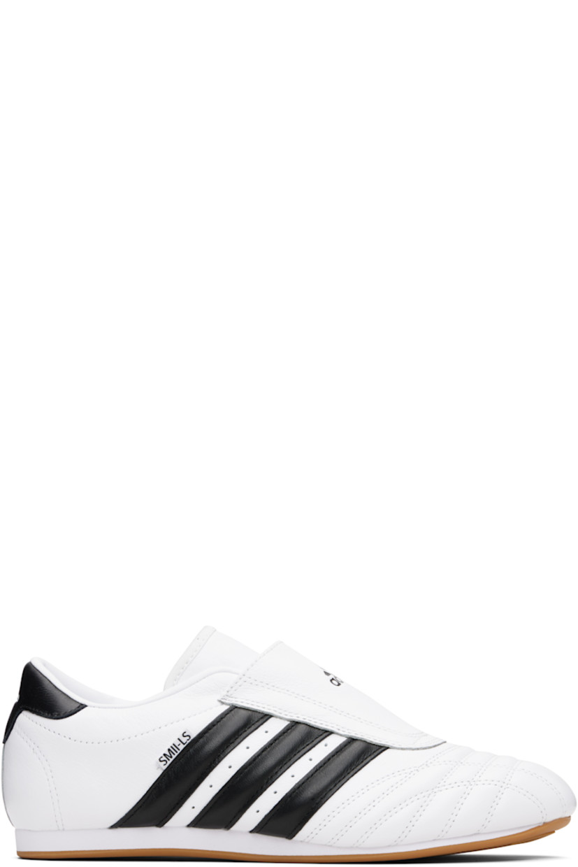 Low-top grained leather slip-on sneakers.

· Quilting at toe
· Logo embossed at vamp
· Concealed elasticized gusset
· Padded collar
· Perforations and signature stripes at sides
· Text flag at outer side
· Logo embossed at heel tab
· Leather and mesh lining
· Treaded rubber sole

Supplier color: Cloud white/Core black/Gum