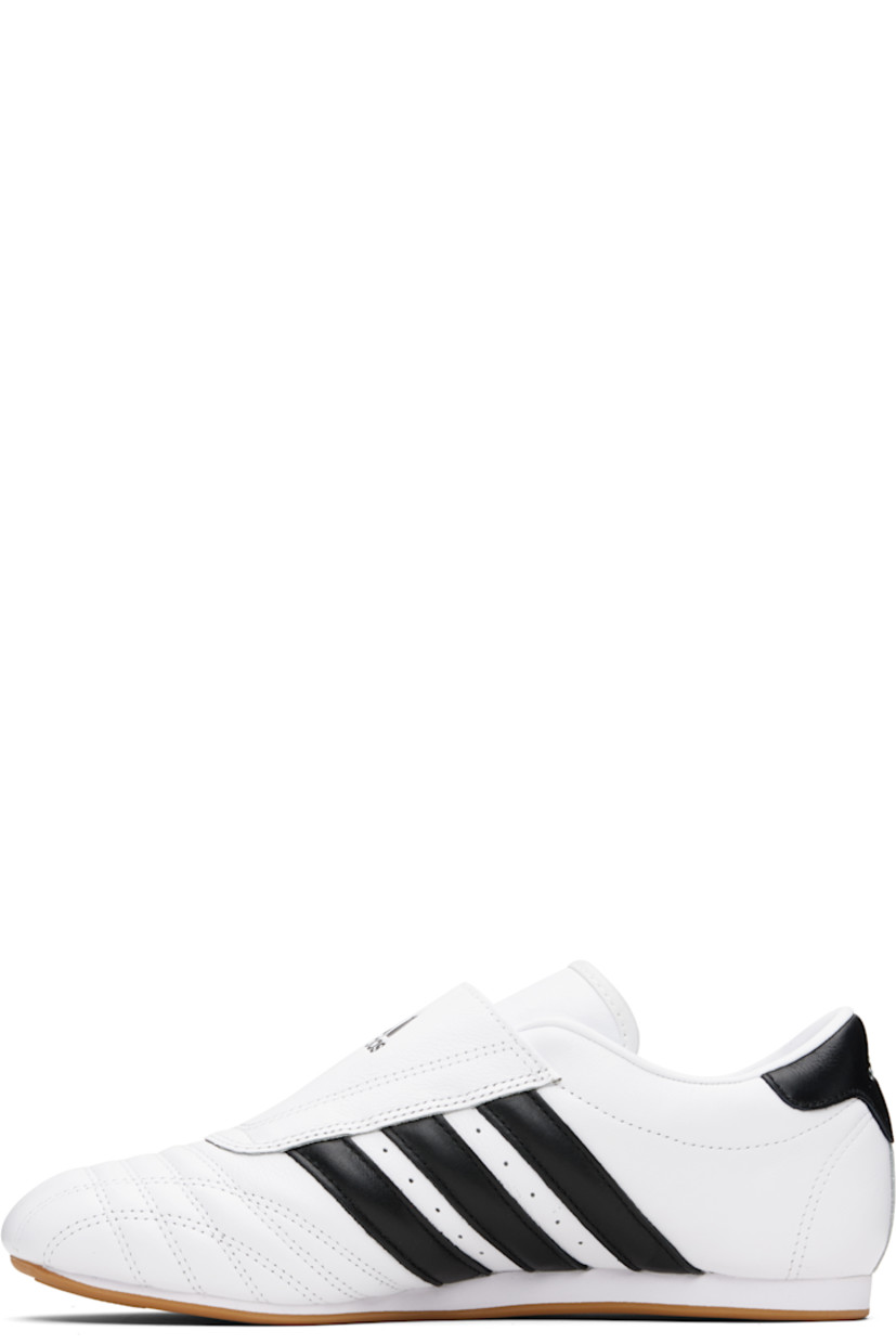 Low-top grained leather slip-on sneakers.

· Quilting at toe
· Logo embossed at vamp
· Concealed elasticized gusset
· Padded collar
· Perforations and signature stripes at sides
· Text flag at outer side
· Logo embossed at heel tab
· Leather and mesh lining
· Treaded rubber sole

Supplier color: Cloud white/Core black/Gum