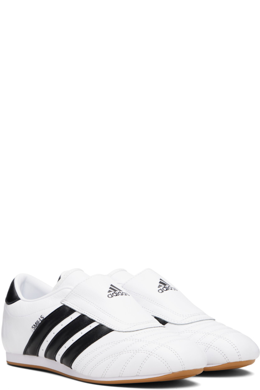 Low-top grained leather slip-on sneakers.

· Quilting at toe
· Logo embossed at vamp
· Concealed elasticized gusset
· Padded collar
· Perforations and signature stripes at sides
· Text flag at outer side
· Logo embossed at heel tab
· Leather and mesh lining
· Treaded rubber sole

Supplier color: Cloud white/Core black/Gum