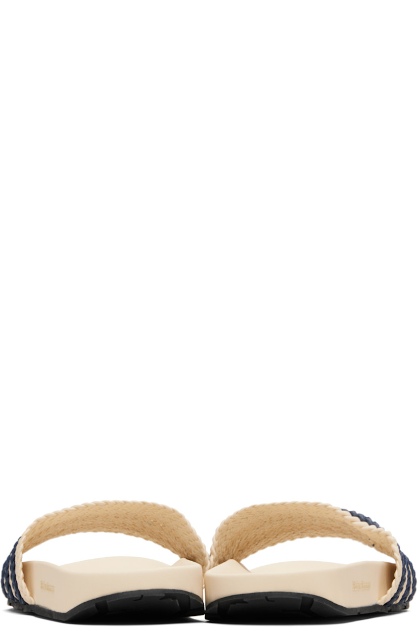Woven leather slides.

· Open toe
· Signature stripes at vamp
· Logo embossed at molded footbed
· Treaded rubber sole

Part of the Wales Bonner x adidas Originals collaboration.

Supplier color: Wonder white/Wonder white/Night indigo