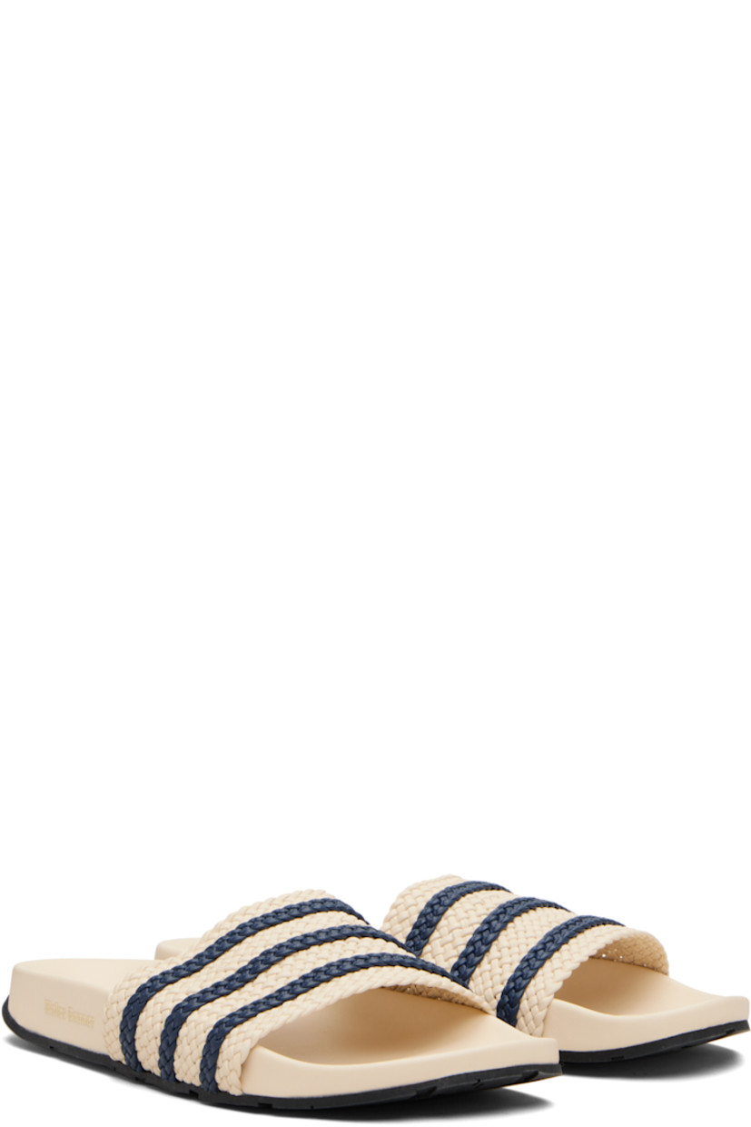 Woven leather slides.

· Open toe
· Signature stripes at vamp
· Logo embossed at molded footbed
· Treaded rubber sole

Part of the Wales Bonner x adidas Originals collaboration.

Supplier color: Wonder white/Wonder white/Night indigo