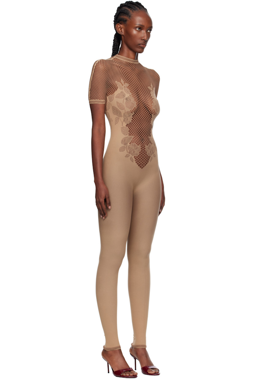 Stretch fishnet jumpsuit. 

· Semi-sheer
· Pointelle-knit floral pattern throughout
· Mock neck
· Button closure with crystal at back collar
· Jacquard logo at back

Supplier color: Beige