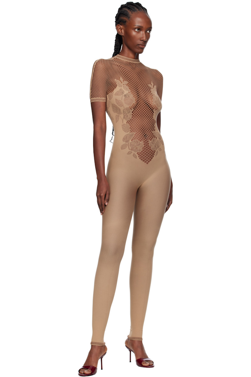 Stretch fishnet jumpsuit. 

· Semi-sheer
· Pointelle-knit floral pattern throughout
· Mock neck
· Button closure with crystal at back collar
· Jacquard logo at back

Supplier color: Beige