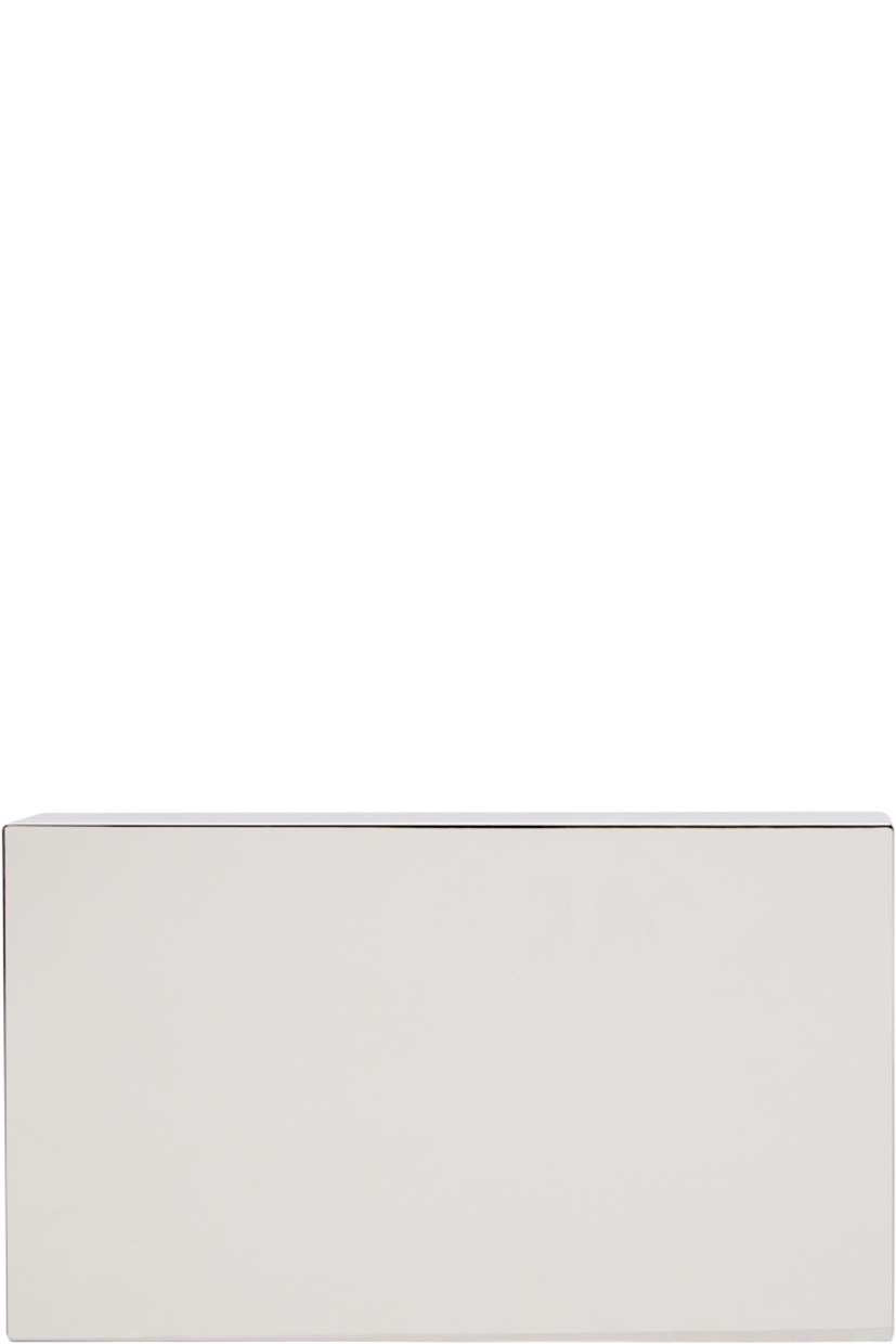 Clutch in silver-tone brass. 

· Logo etched at top 
· Magnetic closure
· Card slot at interior 
· Satin lining
· H4" x W7" x D2"

Supplier color: Silver