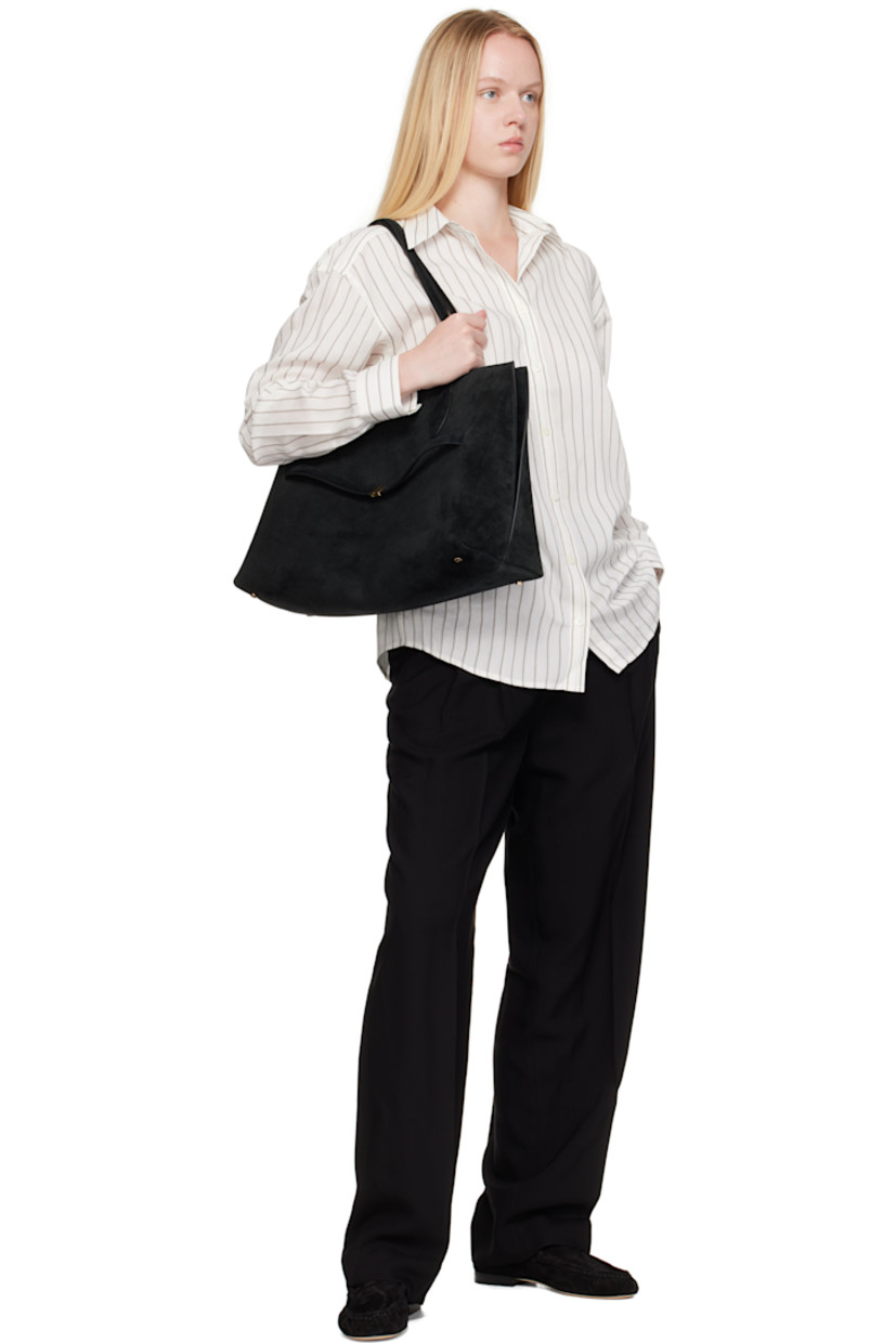 Suede tote. 

· Fixed shoulder straps
· Logo stamp at face
· Removable strap at face
· Lobster clasp closure
· Patch pocket at interior
· Microsuede lining
· Gold-tone hardware
· H11" x W17.5" x D9.5"

Supplier color: Black