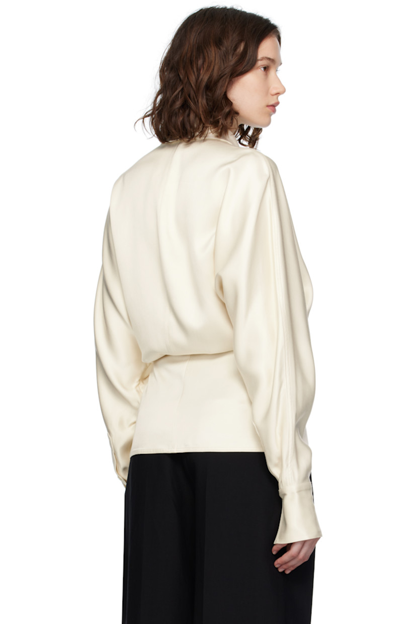 Viscose satin blouse. 
 
· Wrap construction
· Notched lapel
· Topstitched stripes at front
· Single-button closure
· Dolman sleeves
· Buttoned barrel cuffs

Supplier color: Ecru