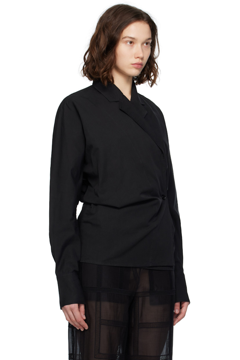 Organic cotton- and linen-blend broadcloth blouse. 
 
· Notched lapel
· Offset button closure
· Topstitched detailing at front
· Dolman sleeves
· Buttoned barrel cuffs

Supplier color: Black