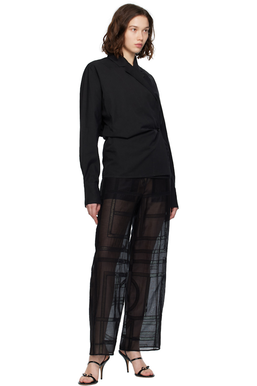 Organic cotton- and linen-blend broadcloth blouse. 
 
· Notched lapel
· Offset button closure
· Topstitched detailing at front
· Dolman sleeves
· Buttoned barrel cuffs

Supplier color: Black