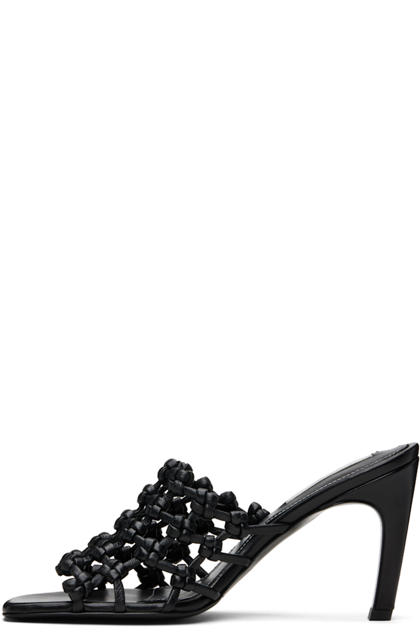 LWG-certified grained goatskin mules. 

· Open square toe 
· Braided strap at vamp
· Logo patch at padded sheepskin footbed
· Covered stiletto heel with rubber injection 
· Leather sole with rubber injection 
· Heel: H3.5"

Supplier color: Black