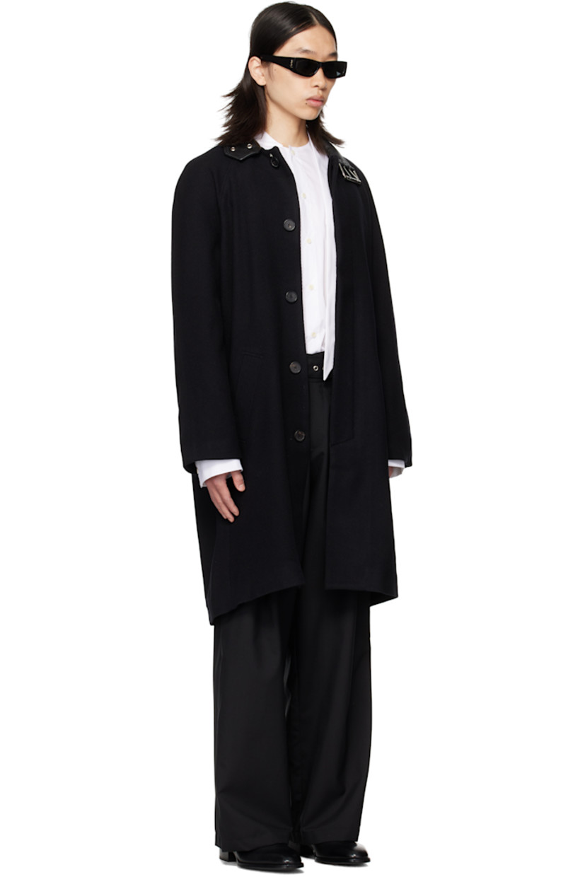 Brushed wool broken twill coat.

· Pin-buckle fastening at buffed sheepskin spread collar
· Concealed button closure
· Welt pockets at waist
· Raglan sleeves
· Central vent at back hem
· Full satin lining

Supplier color: Black