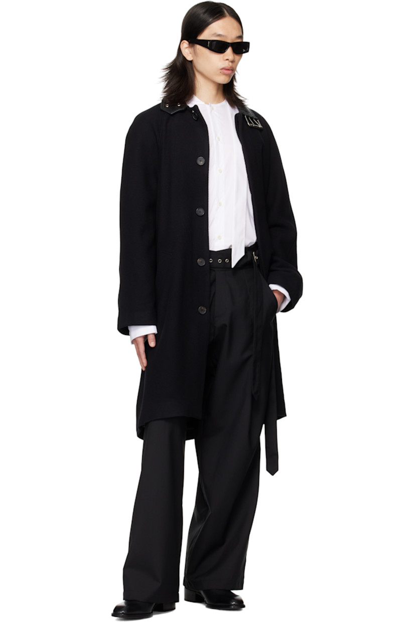 Brushed wool broken twill coat.

· Pin-buckle fastening at buffed sheepskin spread collar
· Concealed button closure
· Welt pockets at waist
· Raglan sleeves
· Central vent at back hem
· Full satin lining

Supplier color: Black