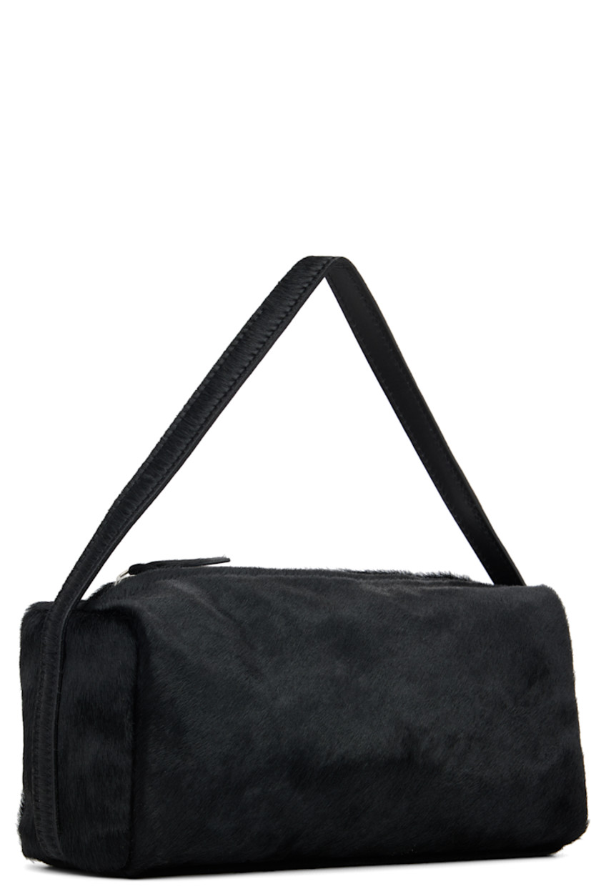 Calf-hair shoulder bag.

· Fixed carry handle
· Zip closure
· Patch pocket at interior
· Twill lining
· H4" x W9" x D4"

Supplier color: Black