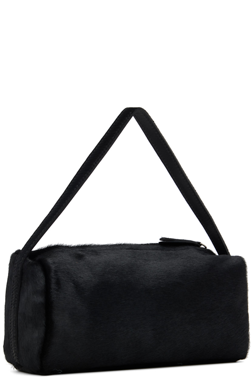Calf-hair shoulder bag.

· Fixed carry handle
· Zip closure
· Patch pocket at interior
· Twill lining
· H4" x W9" x D4"

Supplier color: Black