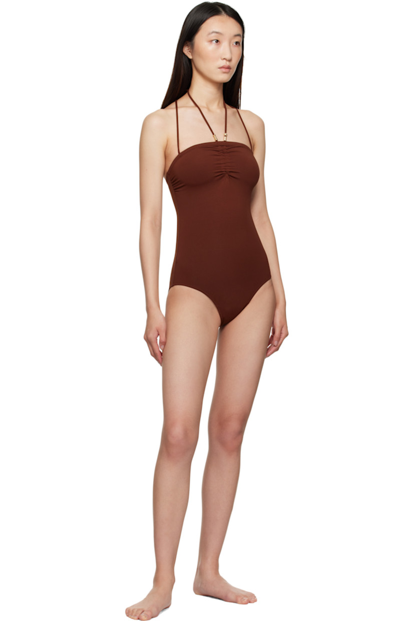 Stretch nylon jersey one-piece swimsuit. 

· Beaded detailing at self-tie halter straps
· Sweetheart neck
· Ruching at chest
· Fixed shoulder straps
· Anti-slip silicone band at interior
· Partial jersey lining 
· Gold-tone hardware

Supplier color: Tortue