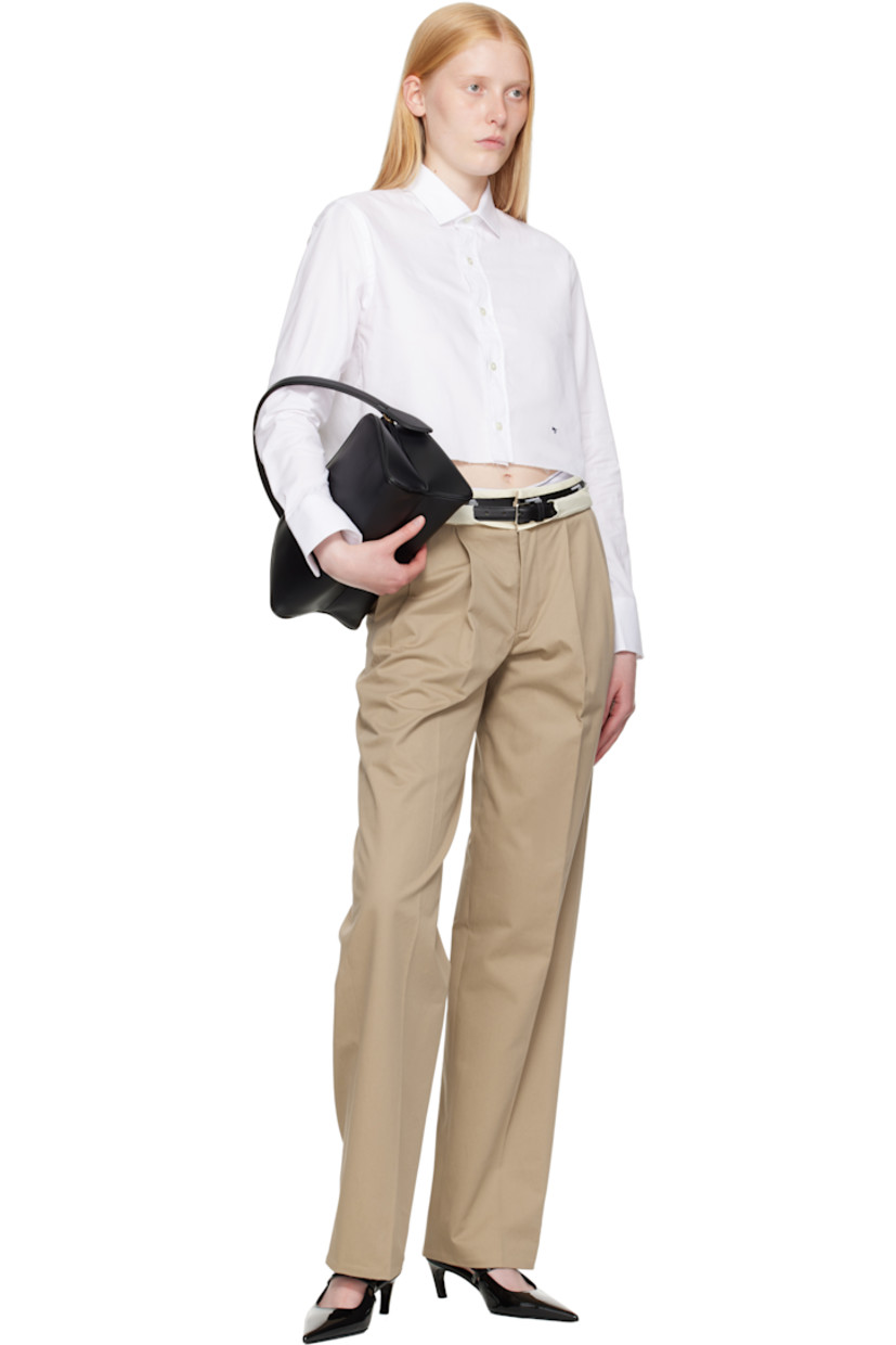 Cotton poplin shirt.

· Spread collar
· Button closure
· Logo embroidered at front
· Raw edge at cropped hem
· Adjustable buttoned barrel cuffs
· Box pleat at back yoke
· Logo-engraved mother-of-pearl hardware

Supplier color: White