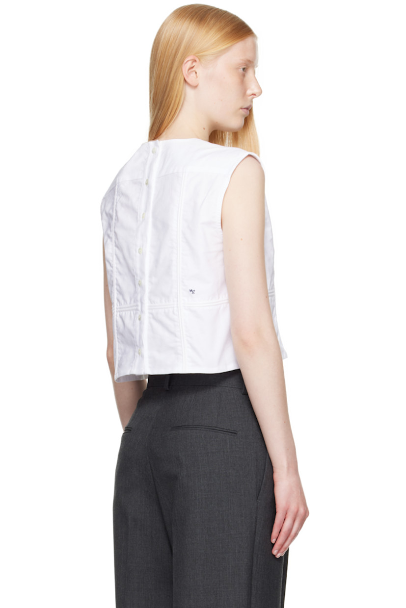 Cotton oxford cloth top.

· Paneled construction
· Round neck
· Box pleat at front yoke
· Button closure at back
· Logo embroidered

Supplier color: White oxford