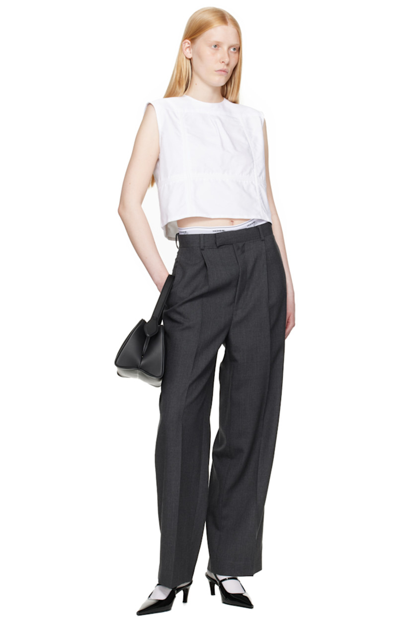 Cotton oxford cloth top.

· Paneled construction
· Round neck
· Box pleat at front yoke
· Button closure at back
· Logo embroidered

Supplier color: White oxford