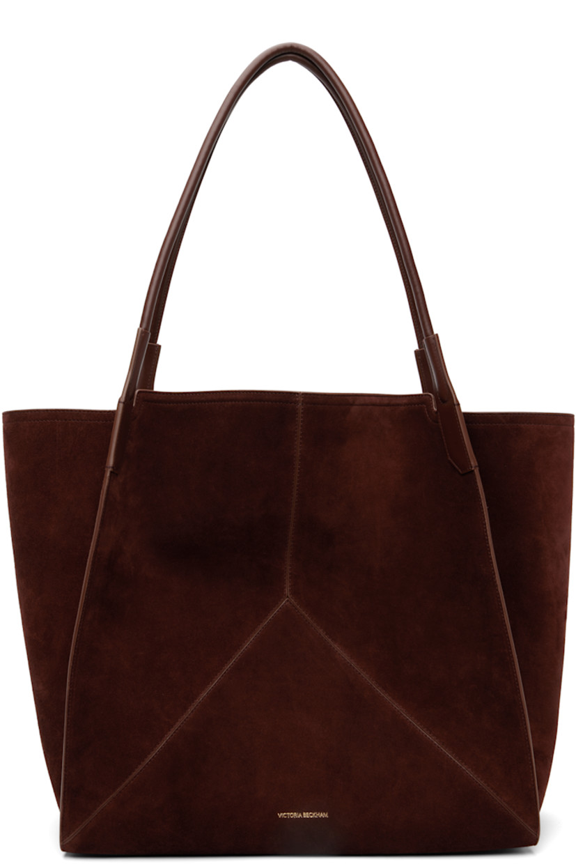 Calfskin suede tote.

· Twin rolled shoulder straps
· Logo stamp at face
· Bumper pads at base
· Patch pocket at interior 
· H15.5" x W15" x D7"

Supplier color: Dark brown
