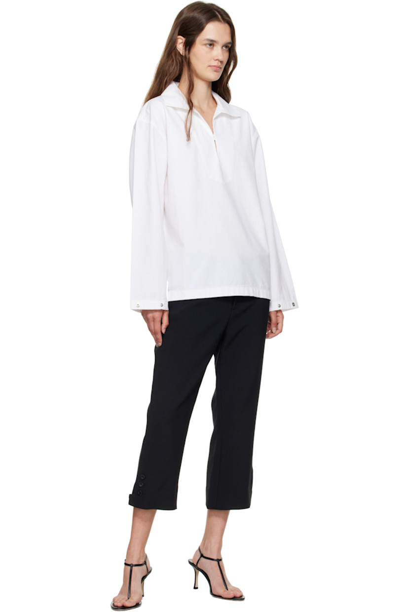 Non-stretch denim blouse.

· Open spread collar
· Button tab at chest
· Dropped shoulders
· Press-stud tab at cuffs
· Contrast stitching in brown at back yoke 

Supplier color: Washed white