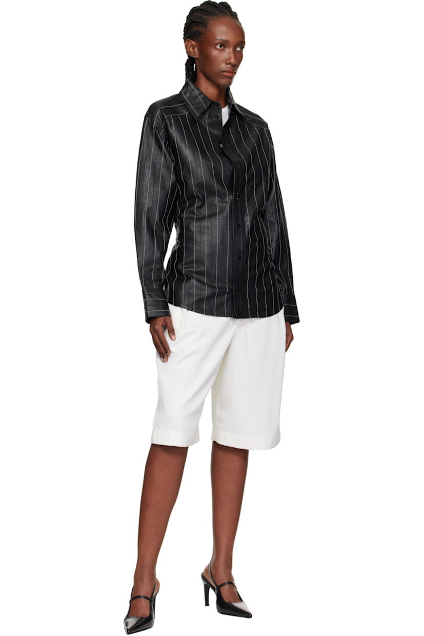 Grained leather shirt. 

· Striped throughout 
· Spread collar 
· Button closure
· Shirttail hem 
· Buttoned barrel cuffs
· Adjustable button tab at back waist
· Contrast stitching in white 

Supplier color: Black/Ivory
