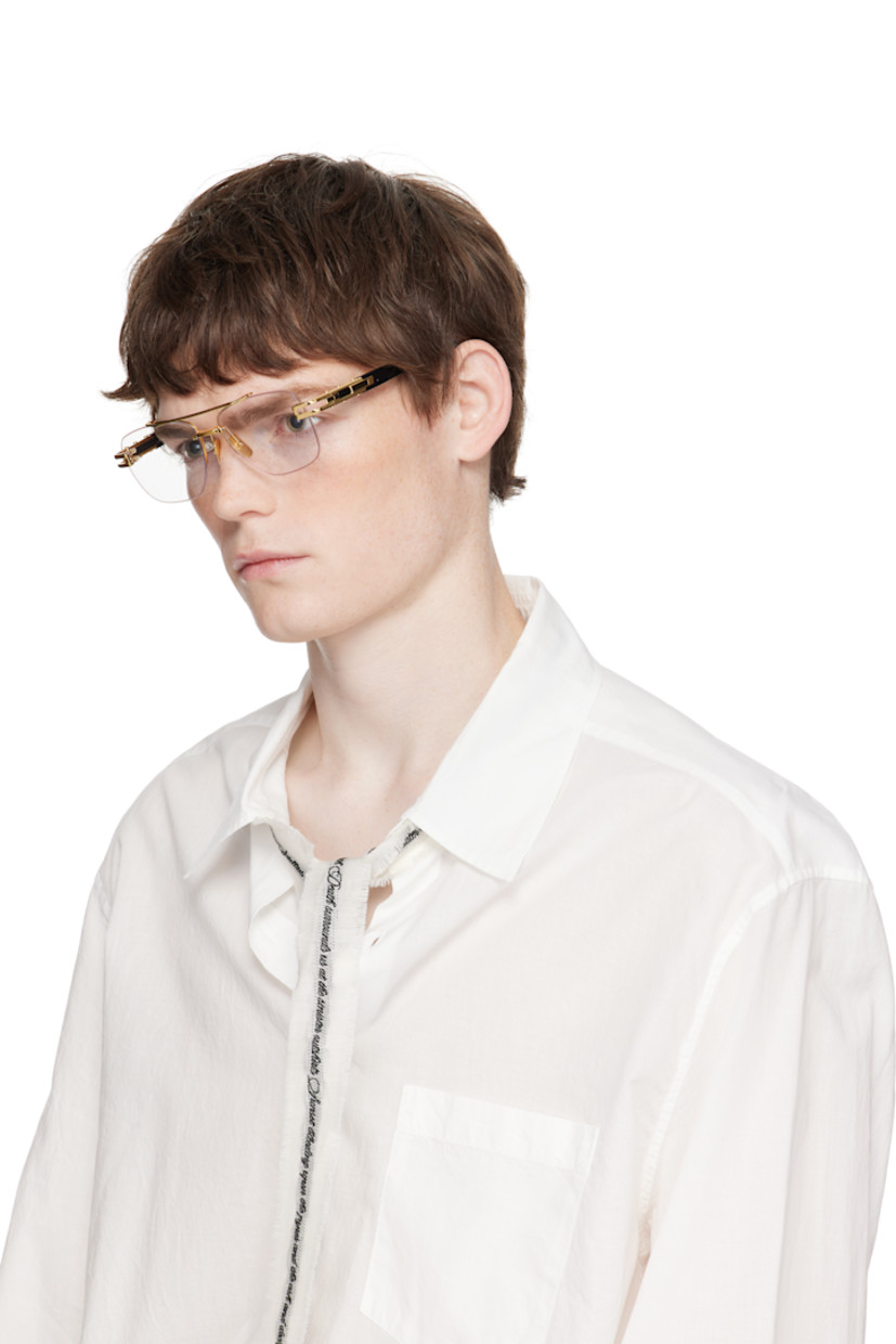 Handcrafted aviator-style titanium- and acetate-frame optical glasses.

· Adjustable titanium nose pads
· Double bridge
· Fluted detailing at temples
· Inset logo at temple tip 
· Includes case
· Size: 57.16 145

Supplier color: Yellow gold/Black