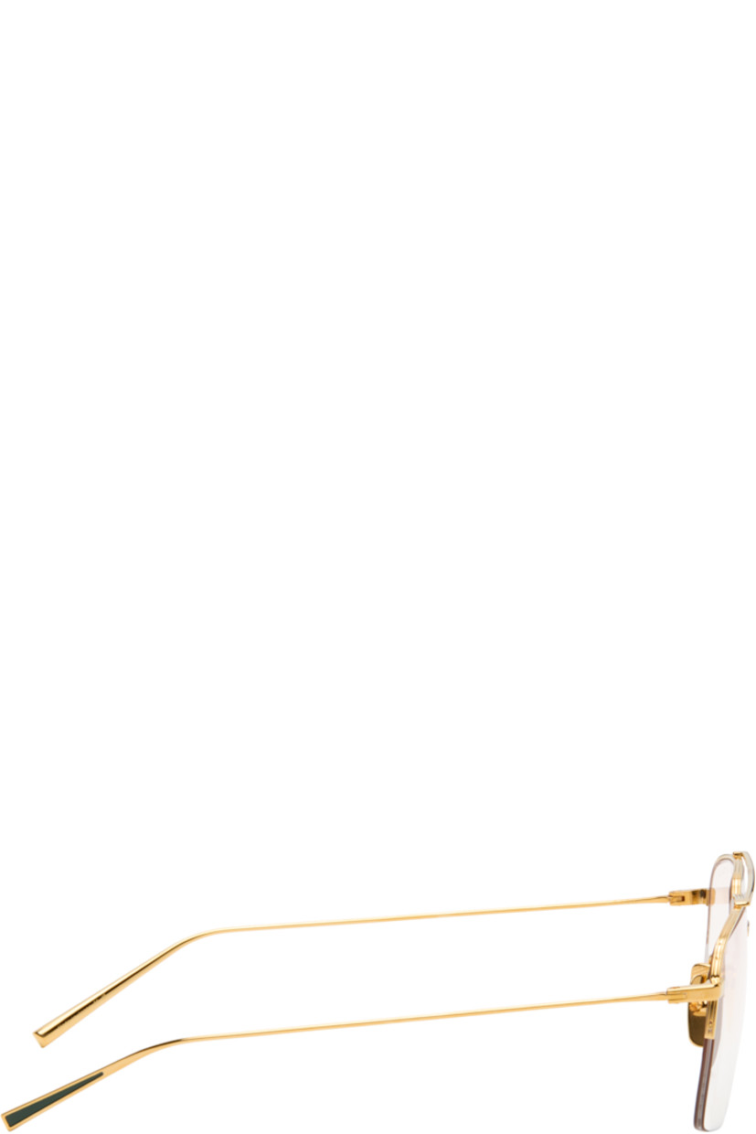 Aviator-style and semi-rimless titanium-frame optical glasses.

· Handcrafted
· Adjustable titanium nose pads
· Top bar
· Inset green enamel at temple tips
· Logo embossed at temple tip
· Includes case
· Size: 56.16 145

Supplier color: Yellow gold