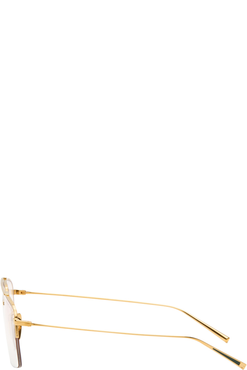 Aviator-style and semi-rimless titanium-frame optical glasses.

· Handcrafted
· Adjustable titanium nose pads
· Top bar
· Inset green enamel at temple tips
· Logo embossed at temple tip
· Includes case
· Size: 56.16 145

Supplier color: Yellow gold