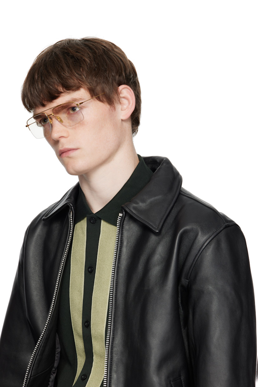 Aviator-style and semi-rimless titanium-frame optical glasses.

· Handcrafted
· Adjustable titanium nose pads
· Top bar
· Inset green enamel at temple tips
· Logo embossed at temple tip
· Includes case
· Size: 56.16 145

Supplier color: Yellow gold