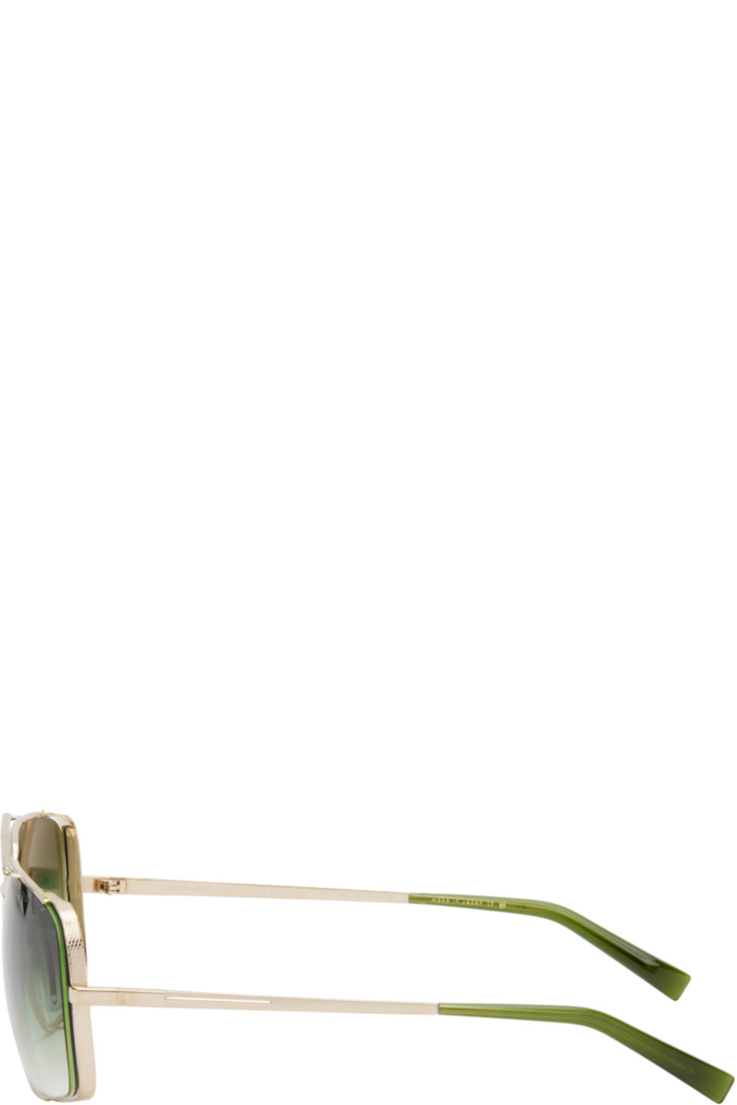Aviator-style titanium-frame sunglasses in gold tone. 

· Handcrafted 
· Anti-reflective CR-39 green lenses
· 100% UVA/UVB protection
· Logo etched at lens
· Adjustable rubber nose pads
· Double bridge
· Engraved detailing at temples
· Transparent green acetate temple tips
· Inset logo hardware at single tip
· Includes case
· Size: 50.16 140

Supplier color: White gold/Crystal black moss