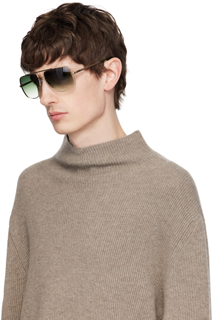 Aviator-style titanium-frame sunglasses in gold tone. 

· Handcrafted 
· Anti-reflective CR-39 green lenses
· 100% UVA/UVB protection
· Logo etched at lens
· Adjustable rubber nose pads
· Double bridge
· Engraved detailing at temples
· Transparent green acetate temple tips
· Inset logo hardware at single tip
· Includes case
· Size: 50.16 140

Supplier color: White gold/Crystal black moss