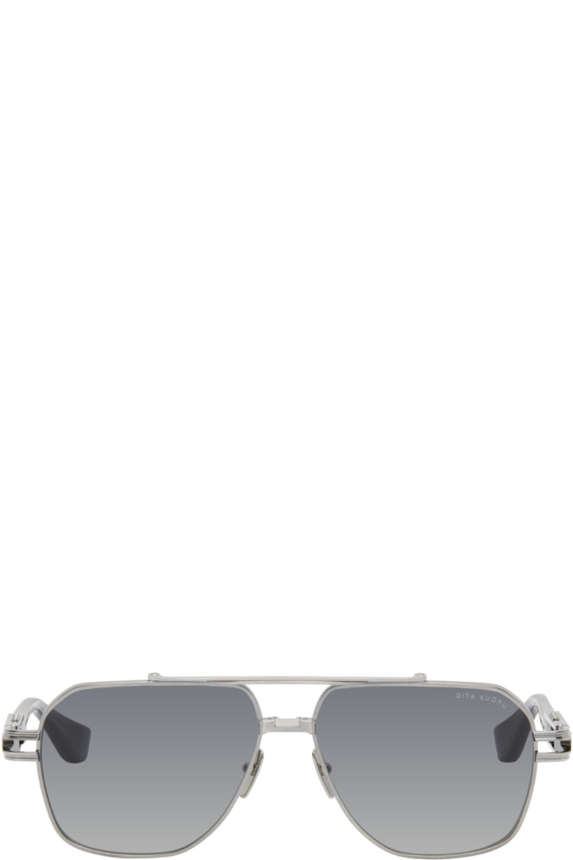 Handcrafted aviator-style titanium-frame sunglasses in gunmetal tone.

· Anti-reflective gray lenses
· 100% UVA/UVB protection
· Logo etched at lens
· Adjustable titanium nose pads
· Top bar 
· Transparent blue acetate temples
· Inset logo hardware at temple tip
· Exposed core wires 
· Includes case
· Size: 61.14 155

Supplier color: Antique silver/Night sky