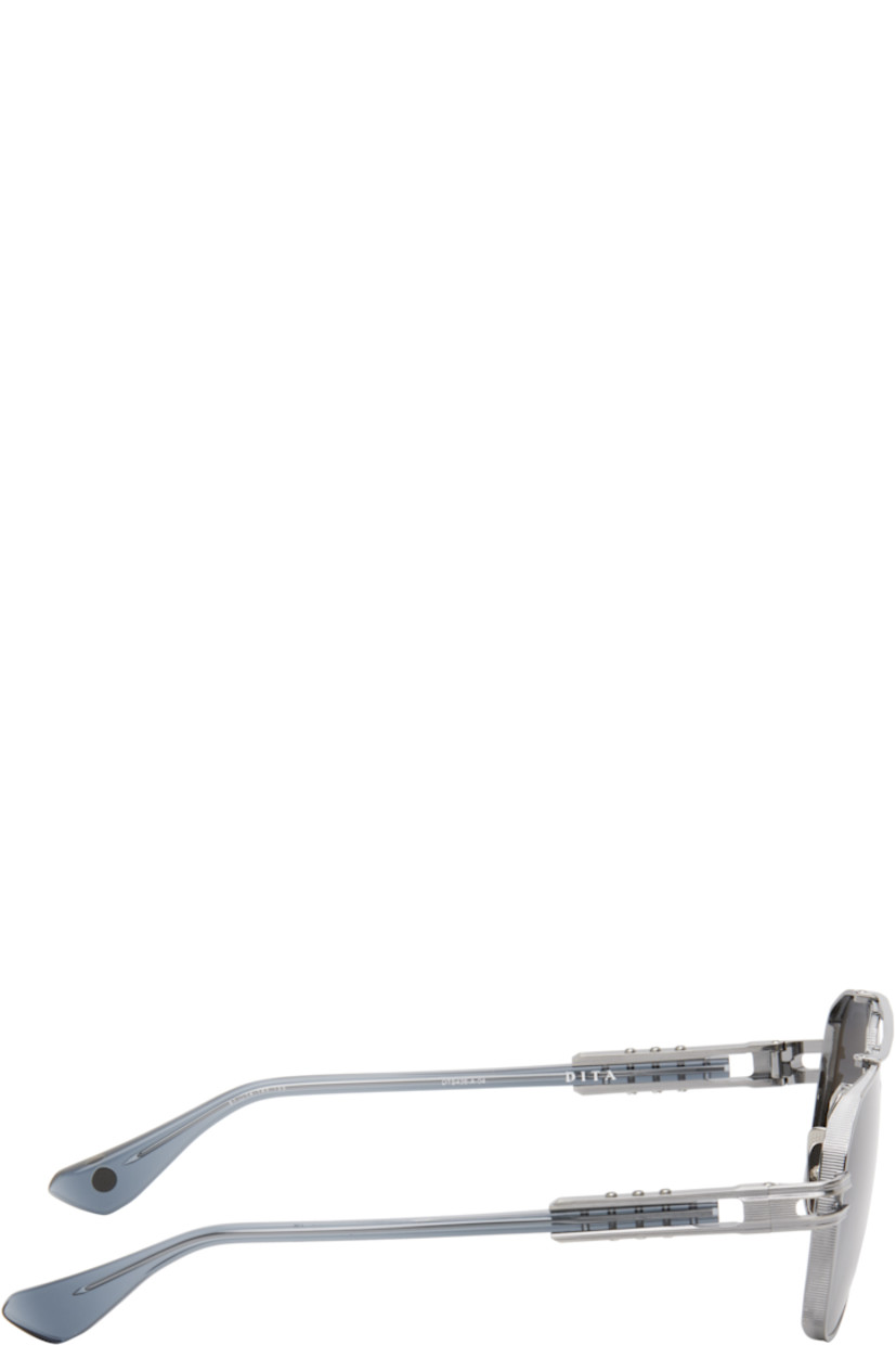 Handcrafted aviator-style titanium-frame sunglasses in gunmetal tone.

· Anti-reflective gray lenses
· 100% UVA/UVB protection
· Logo etched at lens
· Adjustable titanium nose pads
· Top bar 
· Transparent blue acetate temples
· Inset logo hardware at temple tip
· Exposed core wires 
· Includes case
· Size: 61.14 155

Supplier color: Antique silver/Night sky