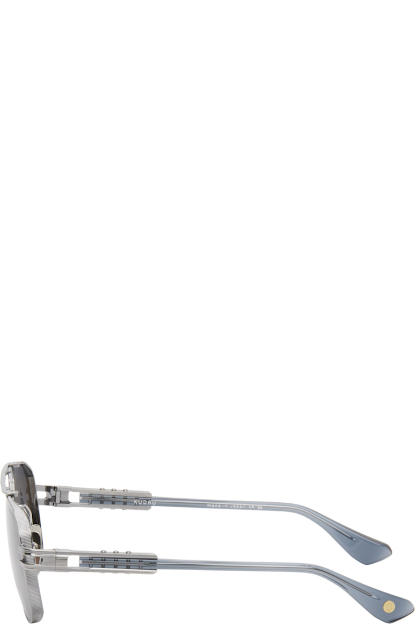 Handcrafted aviator-style titanium-frame sunglasses in gunmetal tone.

· Anti-reflective gray lenses
· 100% UVA/UVB protection
· Logo etched at lens
· Adjustable titanium nose pads
· Top bar 
· Transparent blue acetate temples
· Inset logo hardware at temple tip
· Exposed core wires 
· Includes case
· Size: 61.14 155

Supplier color: Antique silver/Night sky
