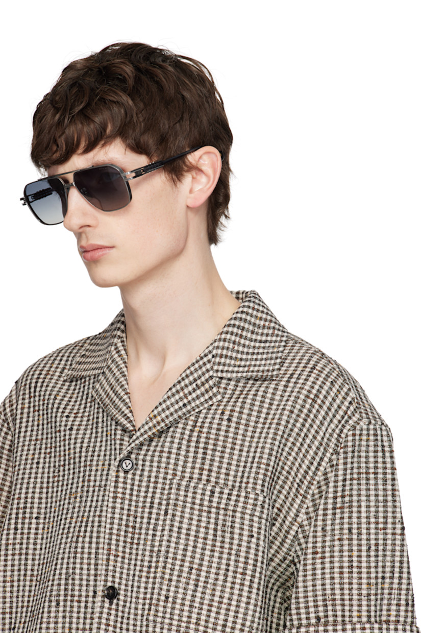 Handcrafted aviator-style titanium-frame sunglasses in gunmetal tone.

· Anti-reflective gray lenses
· 100% UVA/UVB protection
· Logo etched at lens
· Adjustable titanium nose pads
· Top bar 
· Transparent blue acetate temples
· Inset logo hardware at temple tip
· Exposed core wires 
· Includes case
· Size: 61.14 155

Supplier color: Antique silver/Night sky