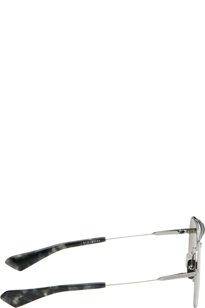 Handcrafted aviator-style titanium-frame sunglasses.

· Anti-reflective CR-39 gray lenses
· Logo etched at lens
· 100% UVA/UVB protection
· Top bar
· Adjustable titanium nose pads
· Blue tortoiseshell acetate temple tips 
· Inset logo at temple tip
· Includes case
· Size: 57.16 144

Supplier color: Black palladium