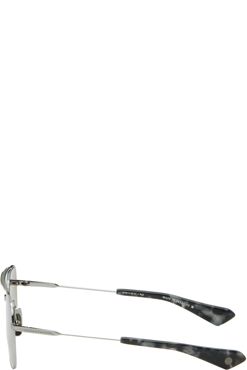 Handcrafted aviator-style titanium-frame sunglasses.

· Anti-reflective CR-39 gray lenses
· Logo etched at lens
· 100% UVA/UVB protection
· Top bar
· Adjustable titanium nose pads
· Blue tortoiseshell acetate temple tips 
· Inset logo at temple tip
· Includes case
· Size: 57.16 144

Supplier color: Black palladium