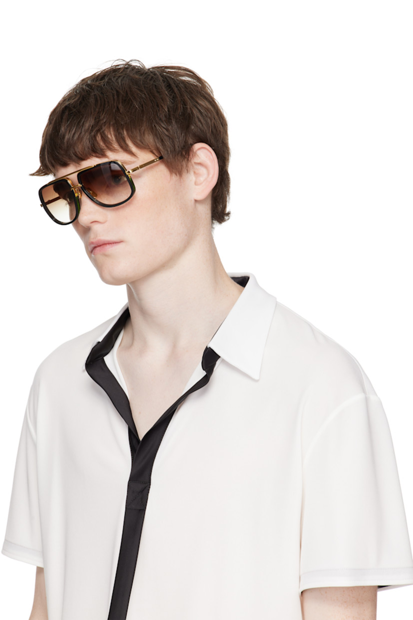 Handcrafted aviator-style titanium- and acetate-frame sunglasses.

· Anti-reflective CR-39 brown lenses
· Logo etched at lens
· 100% UVA/UVB protection
· Top bar
· Adjustable titanium nose pads
· Includes case
· Size: 59.17 127

Supplier color: Black/Yellow gold