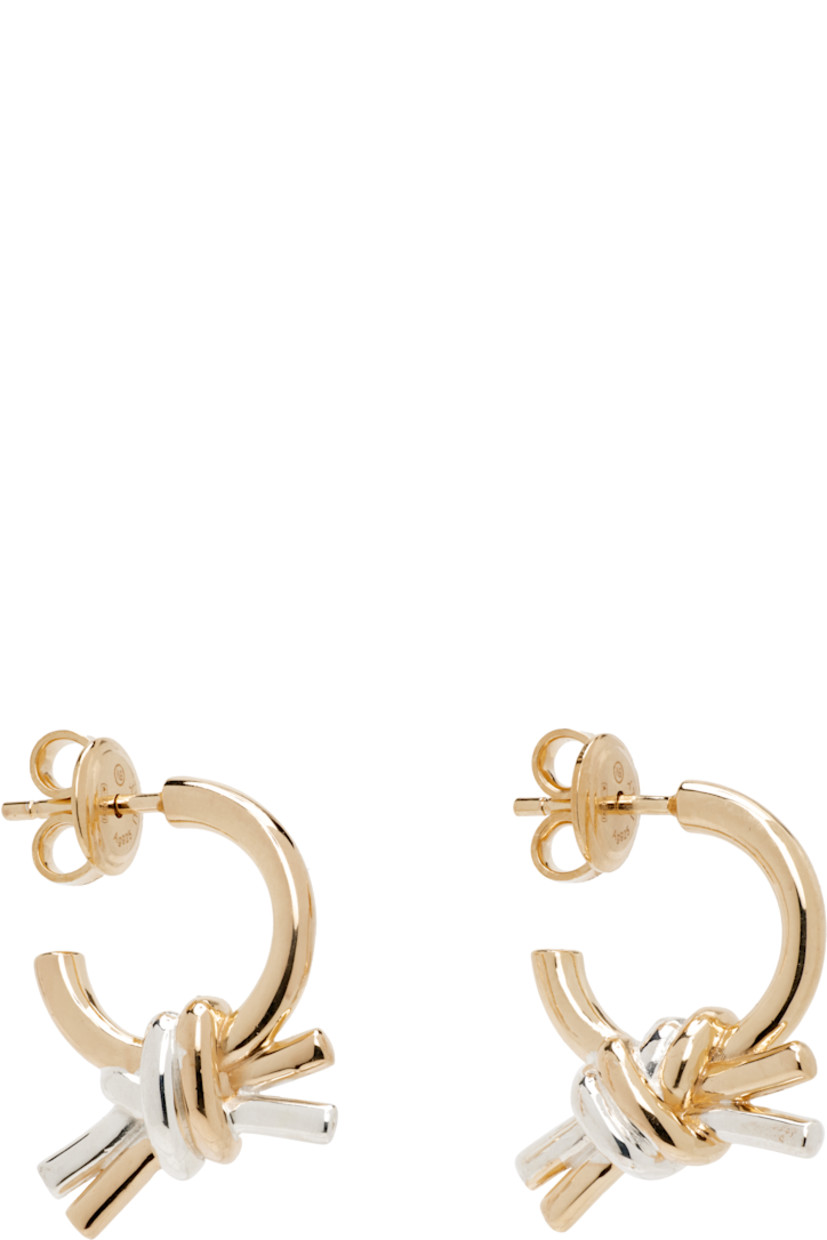 Pair of drop earrings in 18k yellow gold-plated sterling silver.

· Knot with sterling silver detailing
· Post-stud fastening
· H0.75" x W0.5"

Supplier color: Yellow gold
