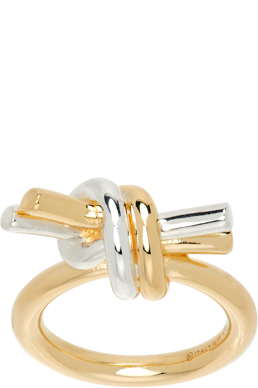 Tubular-band ring in 18k gold-plated sterling silver. 

· Sterling silver knot at face
· Logo and hallmarking at inner band

Supplier color: Silver/Yellow gold