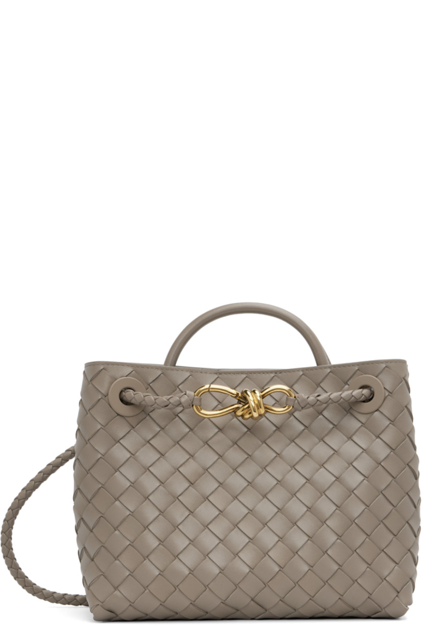 Intrecciato-woven lambskin top handle bag.

· Rolled carry handle
· Sliding shoulder strap
· Knotted hardware at strap
· Magnetic closure
· Gold-tone hardware
· Zip pocket at interior
· H7.75" x W9.5" x D4.5"

Supplier color: Limestone