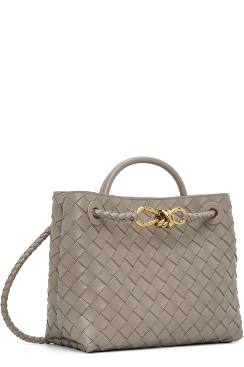 Intrecciato-woven lambskin top handle bag.

· Rolled carry handle
· Sliding shoulder strap
· Knotted hardware at strap
· Magnetic closure
· Gold-tone hardware
· Zip pocket at interior
· H7.75" x W9.5" x D4.5"

Supplier color: Limestone