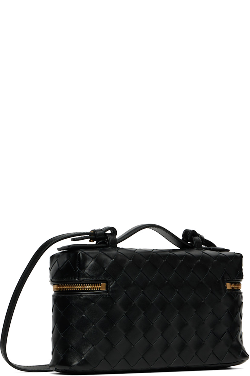Intrecciato-woven grained calfskin messenger bag.

· Fixed carry handle
· Adjustable and detachable crossbody strap
· Two-way zip closure
· Card slot at interior
· H5" x W9" x D2.5"

Supplier color: Black